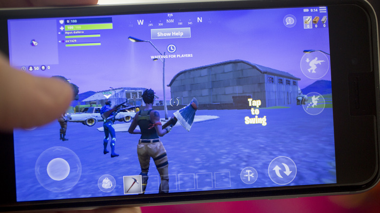 a gamer playing Fortnite on an iPhone