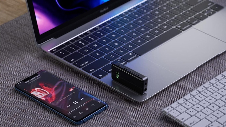 Fiio BTR3K Bluetooth headphone amp kept on a laptop