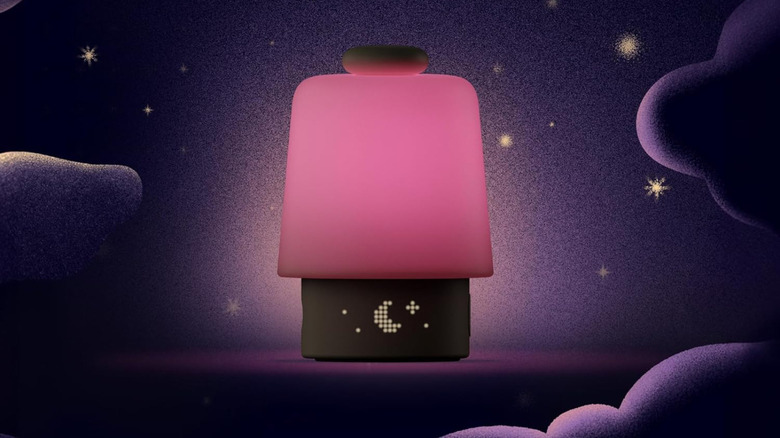 A Hatch Baby sound machine emitting pink light