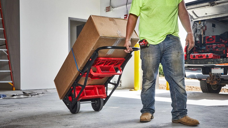 Person pulling dolly carrying furniture