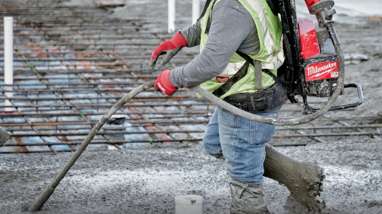 Worker using concrete vibrator