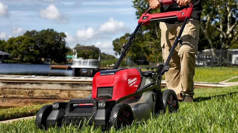 Person using self-propelled mower