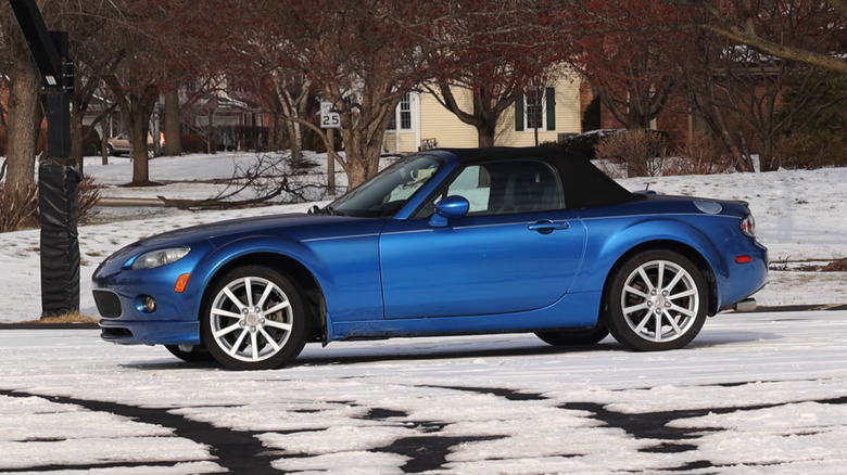A side on shot of a blue Mazda MX-5 NC
