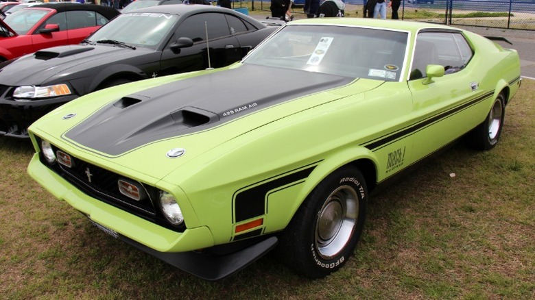 Green and black 1971 Ford Mustang Mach 1 429 parked at a car show
