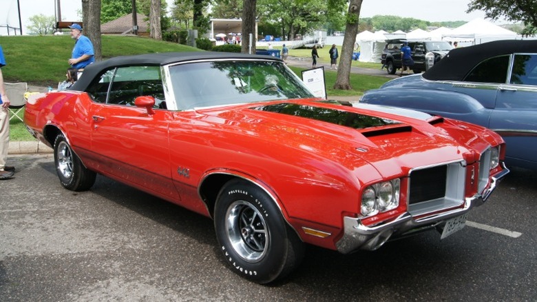 Red and black Oldsmobile 442 convertible parked at a car show