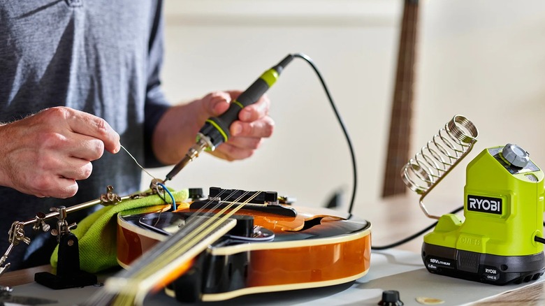 A person using a Ryobi soldering kit.