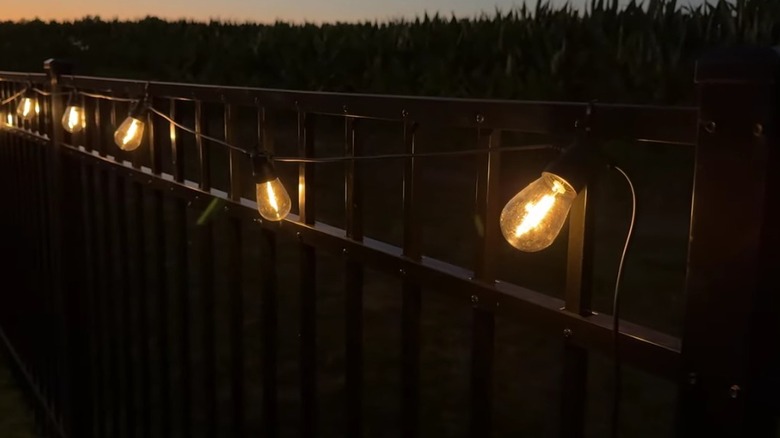 Brightech Ambiance Pro Solar String Lights on a fence.