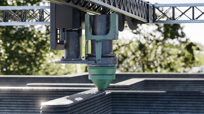 3D printer generating housing materials.