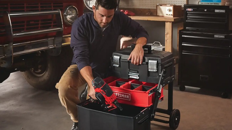 A person looking through a Craftsman rolling tool box.