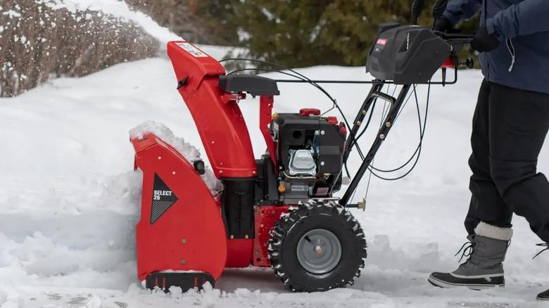 A person using a Craftsman snow blower.