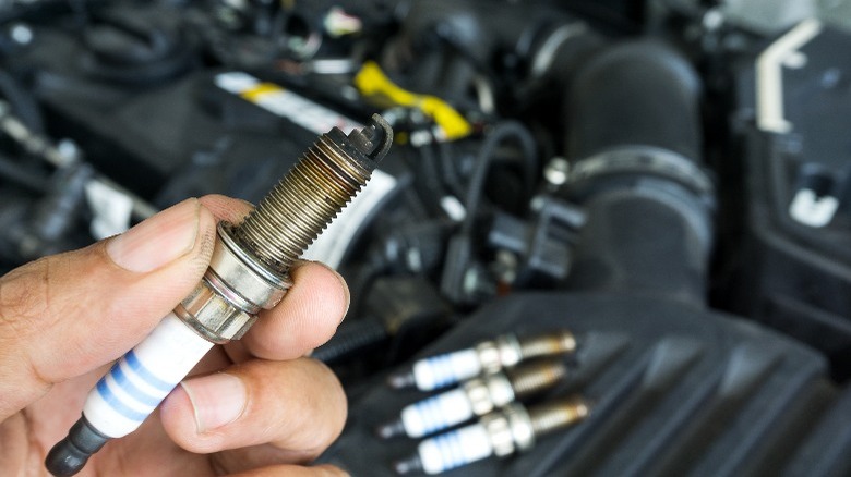 A spark plug in a man's hand