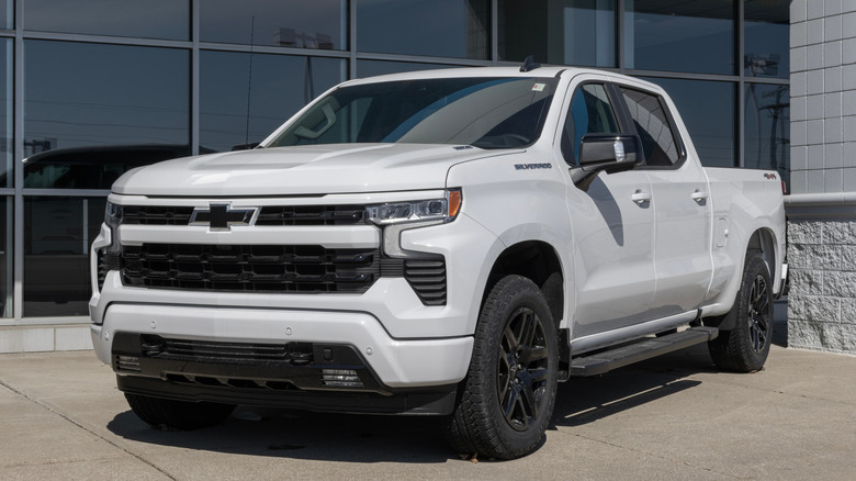 A Chevrolet Silverado 1500 white pickup truck parked