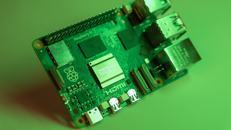 A close up shot of a Raspberry Pi 5 circuit board under green-tinted lighting