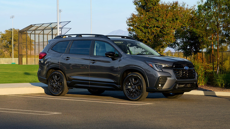 2025 Subaru Ascent backed into a parking spot with a baseball field behind it