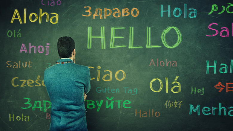 man with board of different languages