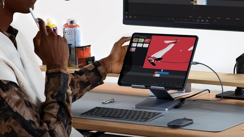 Editing videos on an iPad placed on an Anker stand, while connected to an external monitor