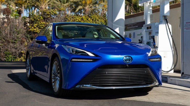 Blue Toyota Mirai filling up at a hydrogen station
