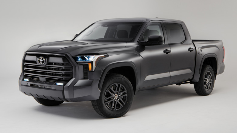Front 3/4 view of gray Toyota Tundra pickup parked in studio.