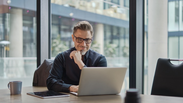 man on computer smiling