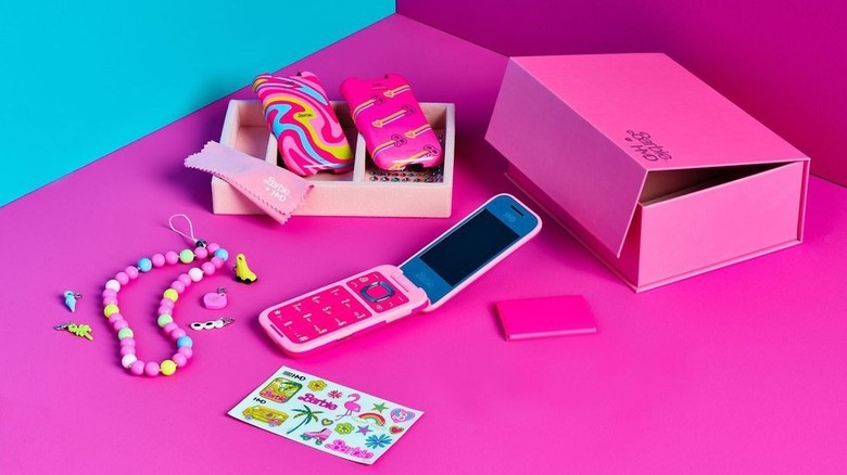 The HMD Barbie Phone next to its box and accessories.