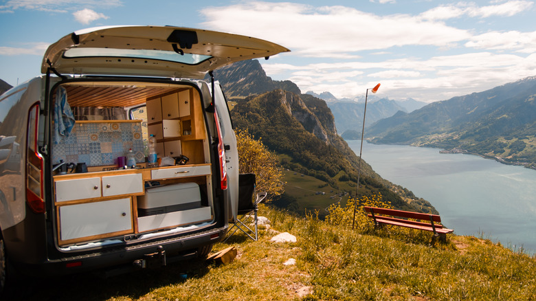 Campervan parked by lake