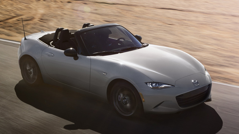 Mazda Miata driving on racetrack in sunny conditions
