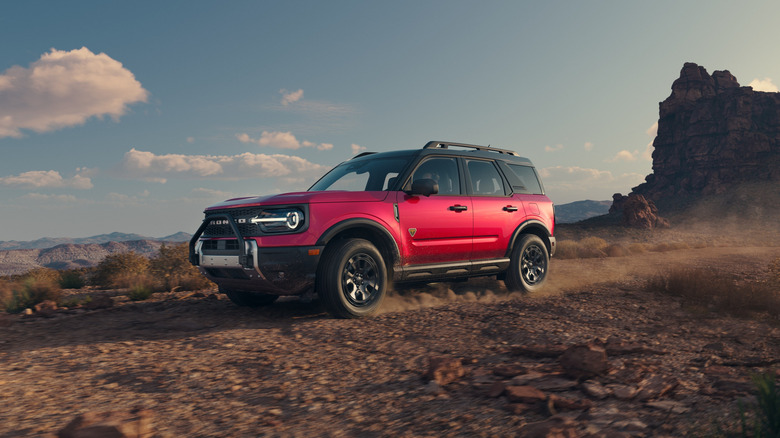 A red 2026 Ford Bronco Sport Badlands driving on a mountain trail