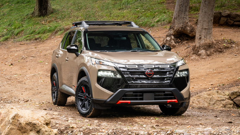 A light brown 2026 Nissan Rogue Rock Creek parked on a dirt road