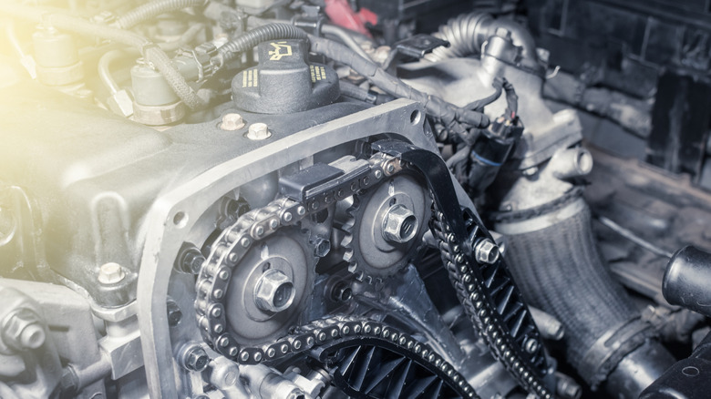 A close-up of an engine's timing chain and tensioner system.