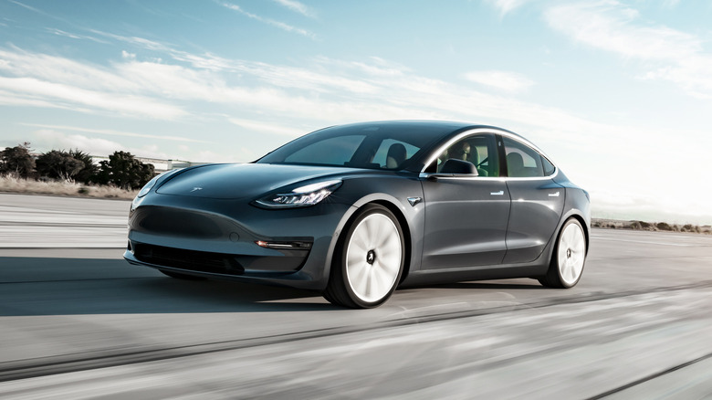 Gray Tesla Model 3 on the road