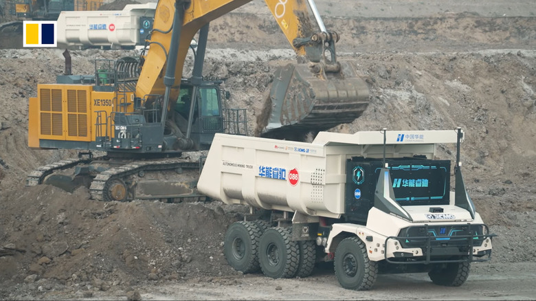 Huaneng Ruichi autonomous mining truck being loaded at an open-pit mine