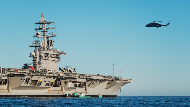 Military helicopter approaches USS Dwight D. Eisenhower carrier