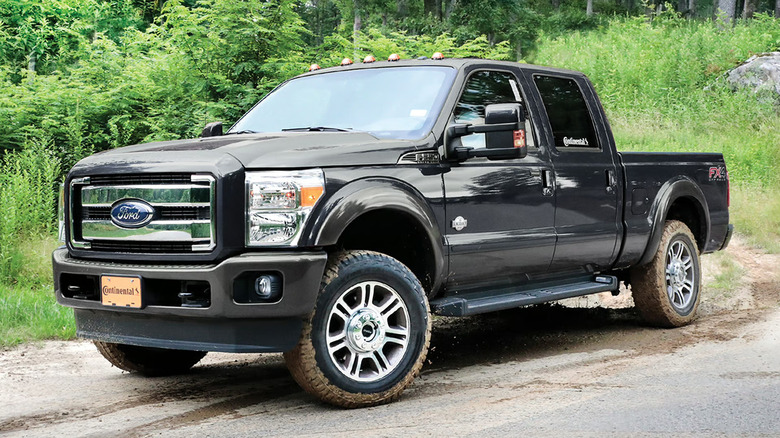 A black Ford F-250 Super Duty wearing dirty Continental TerrainContact A/T2 tires