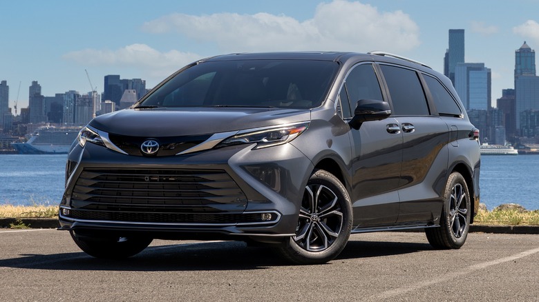 A black 2025 Toyota Sienna parked, a city skyline in the background.