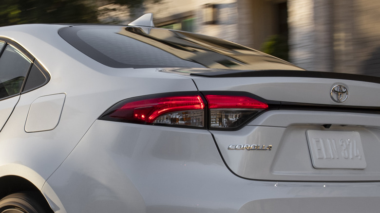 Rear 3/4 view of 2026 Toyota Corolla in wooded setting