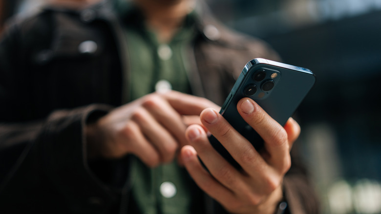 Close-up of person's hand holding iPhone