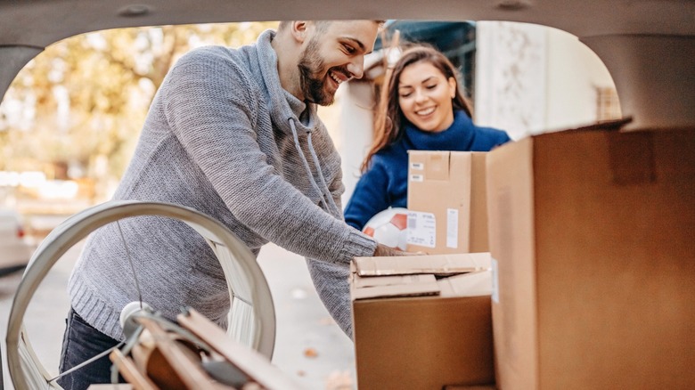 Couple loading up a vehicle