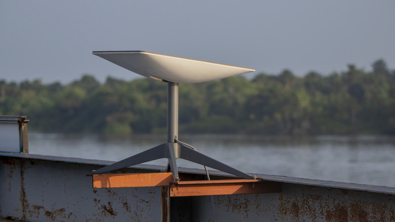 Starlink satellite mounted on pier overlooking water