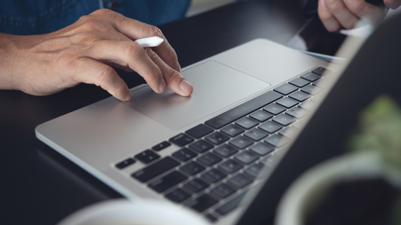 Man typing on Macbook
