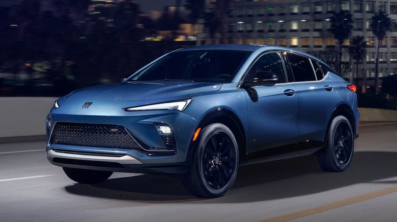 Blue Buick Envista driving on an urban street at night