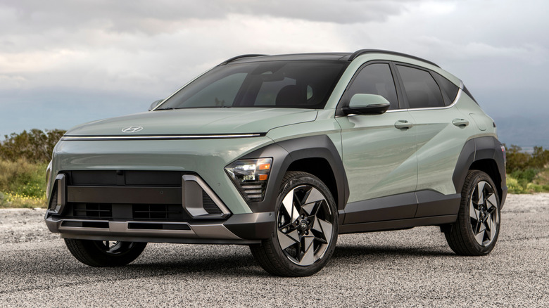Green Hyundai Kona parked on a desert road