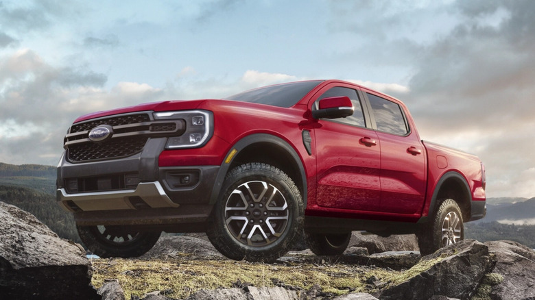 Red Ford Ranger parked on rocks