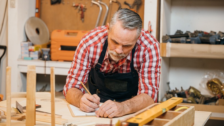 Woodworker looking at plans
