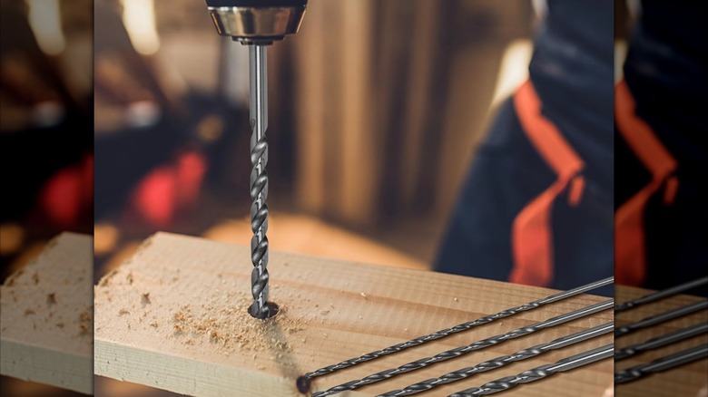 Drill boring a hole into wood
