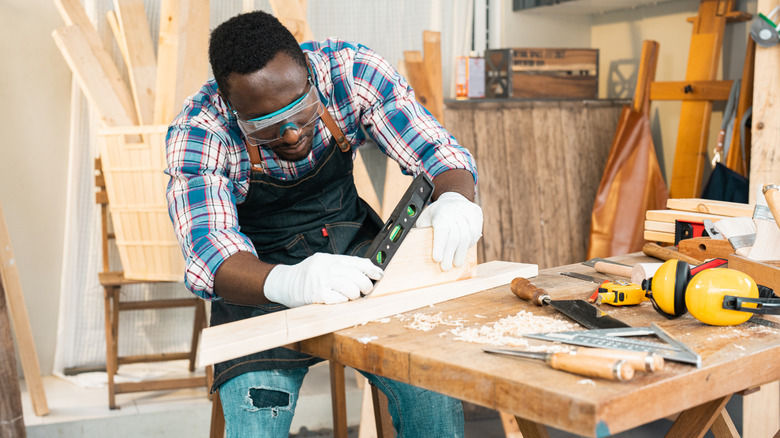 Woodworker measuring wood