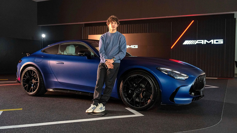 Kimi Antonelli standing next to his Mercedes-AMG GT 63