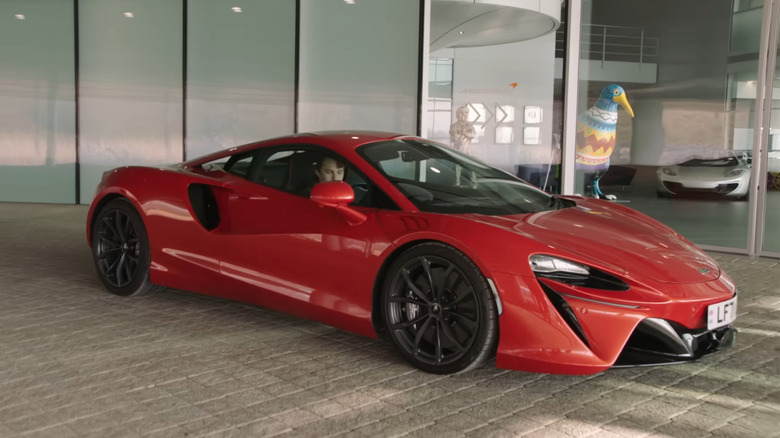 A side on shot of Oscar Piastri in his McLaren Artura