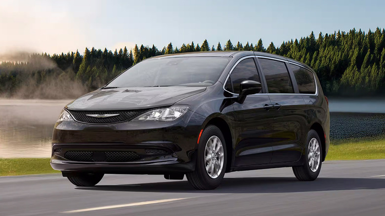 A black Chrysler Voyager driving