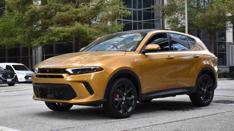 A yellow Dodge Hornet driving
