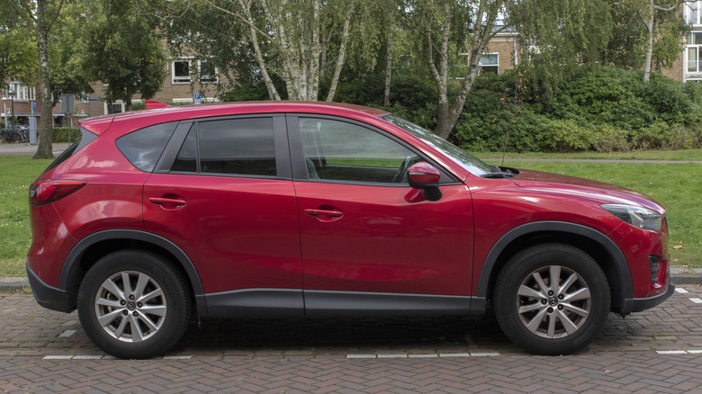 A red Mazda CX-5 parked on a street.